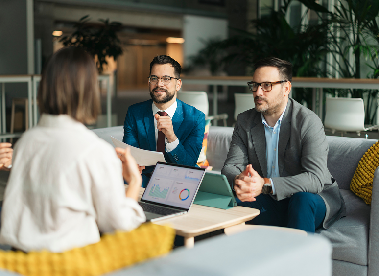 Professionals discussing work in office setting