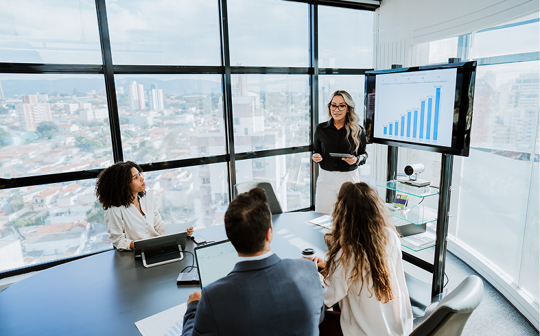 Professional woman presenting data to colleagues.